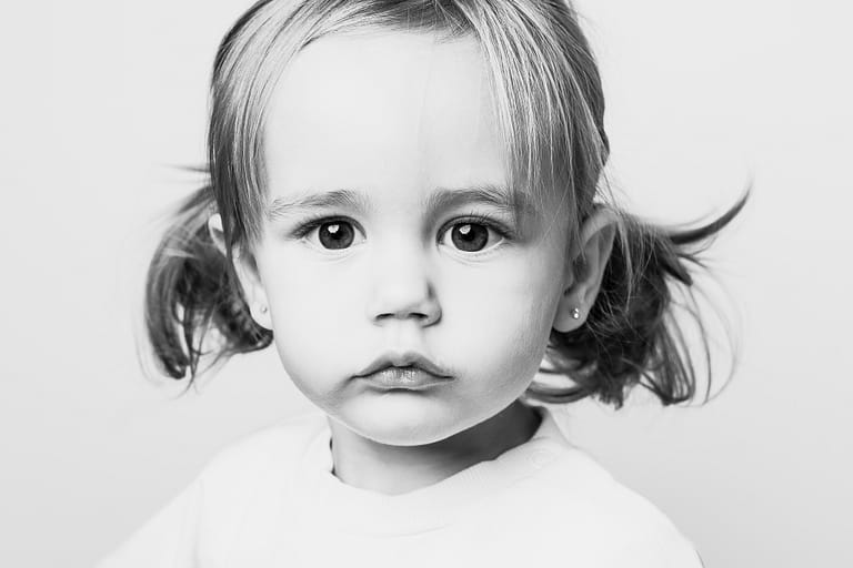 Black and white personality portrait of a child with a calm expression, photographed in Cleveland